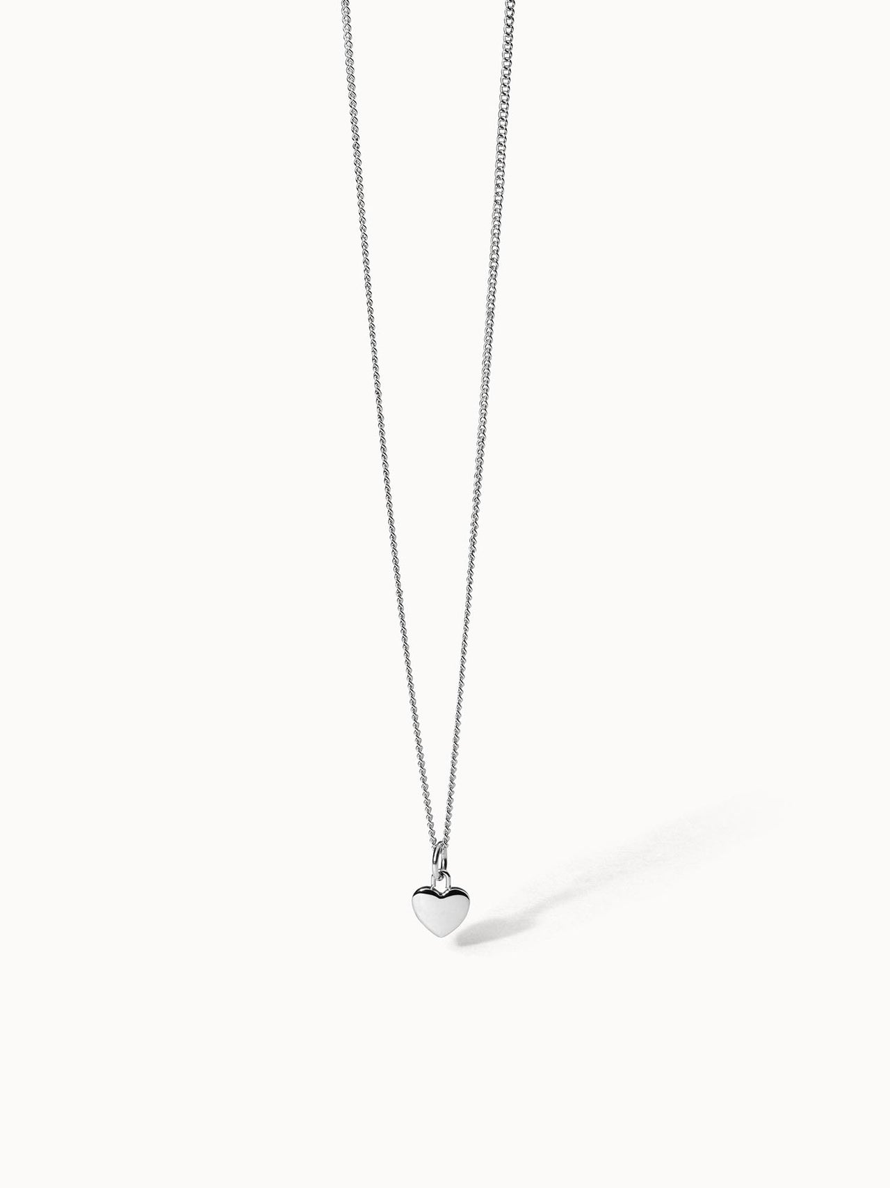 PURELEI Heart Charm Kette aus silbernem Edelstahl mit filigranem Herzanhänger auf weißem Hintergrund, elegant und feminin.
