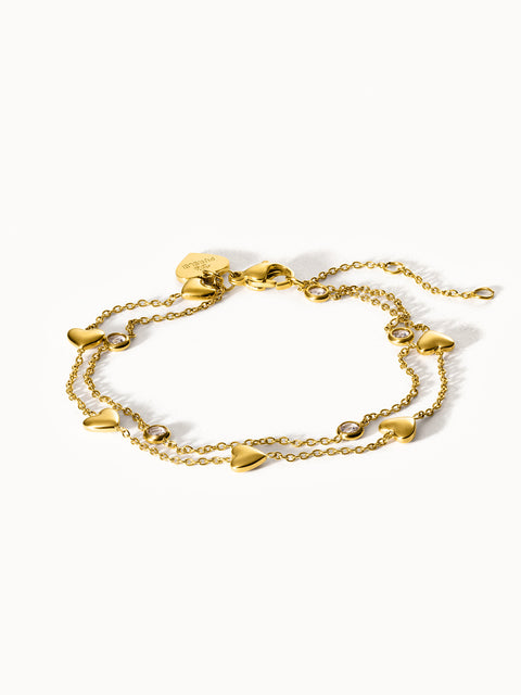Goldenes Armband mit Herzanhängern und funkelnden Details von PURELEI.