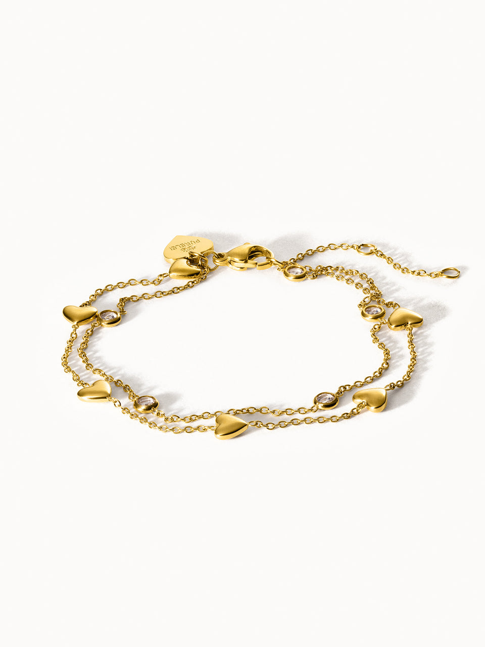 Goldenes Armband mit Herzanhängern und funkelnden Details von PURELEI.