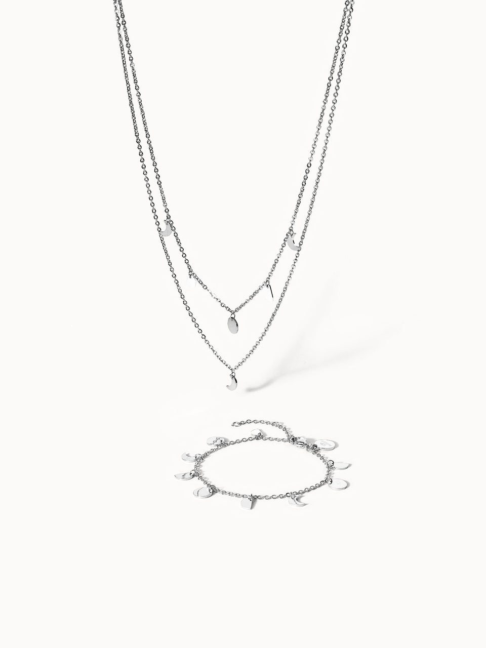 Silberne Kette und Armband mit Mondanhängern von PURELEI, elegant und modern.