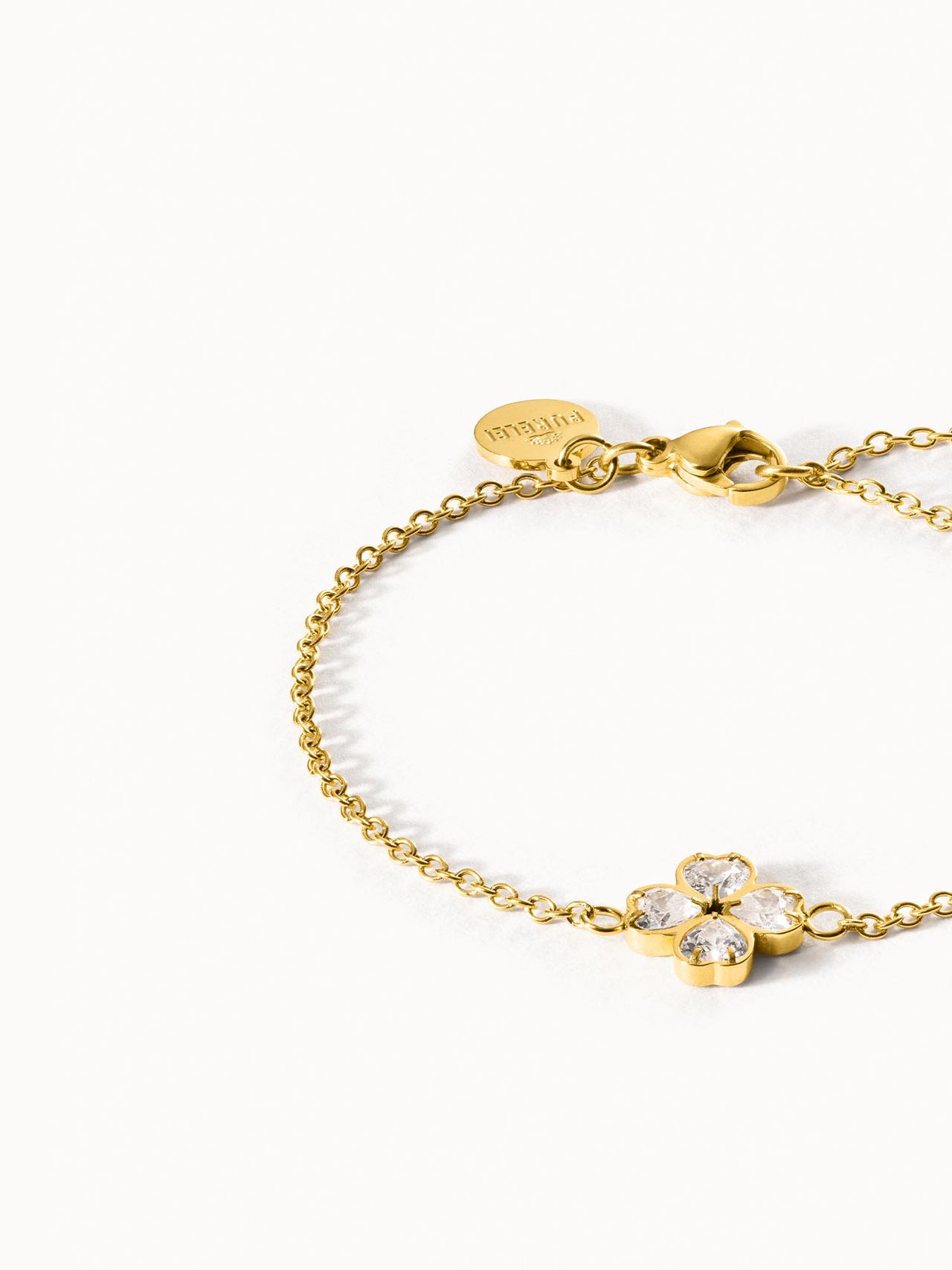 Goldenes Armband mit blütenförmigem Design und funkelnden Steinen von PURELEI.