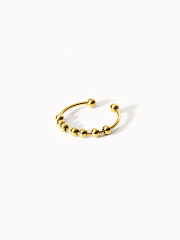Goldenes PURELEI Ringdesign mit Kugeln, modern und elegant.