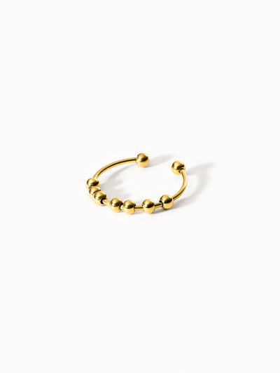 Goldenes PURELEI Ringdesign mit Kugeln, modern und elegant.