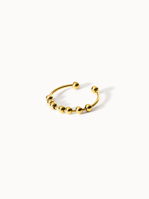 Goldenes PURELEI Ringdesign mit Kugeln, modern und elegant.