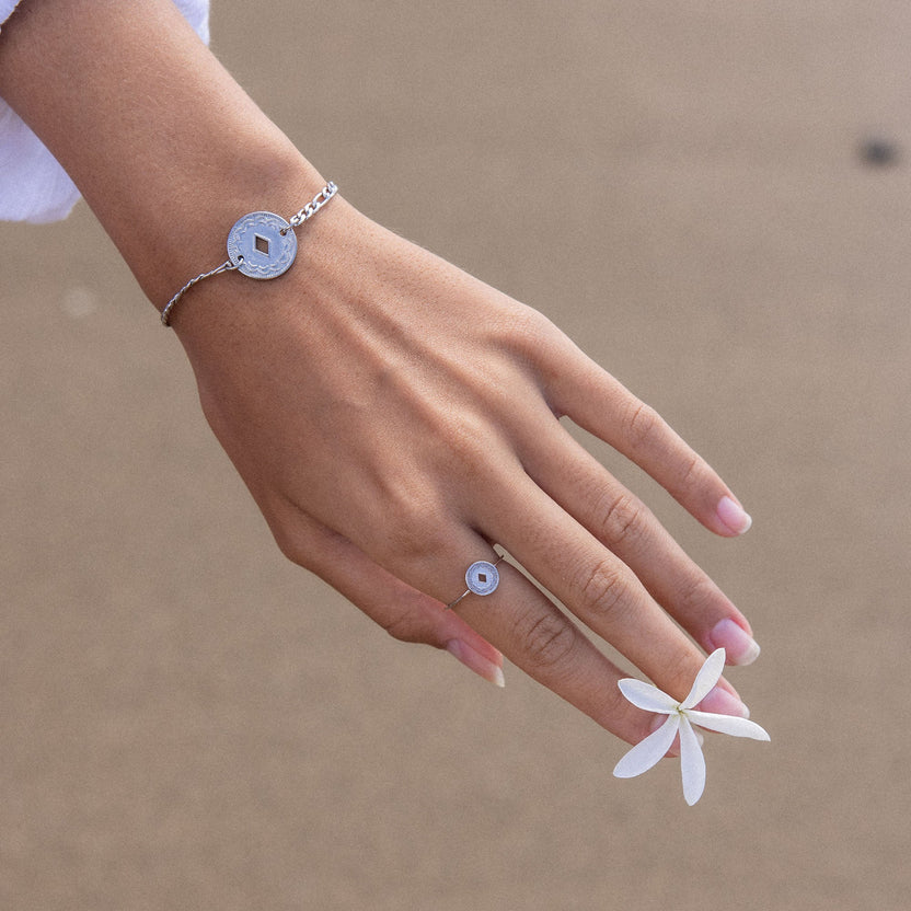 Silbernes Armband und Ring mit kreisförmigem Design, getragen mit Blüte, PURELEI Stil.