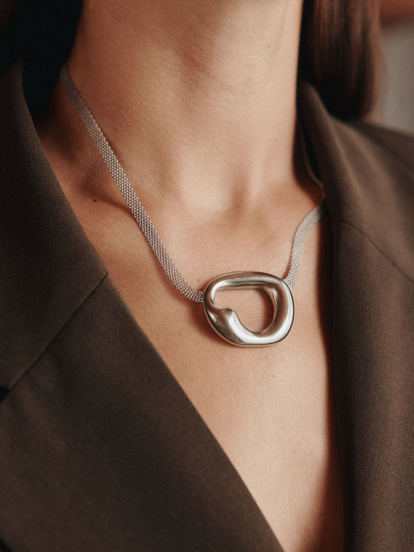 Silberne Kette mit organischem Anhänger, elegant getragen, inspiriert von PURELEI.