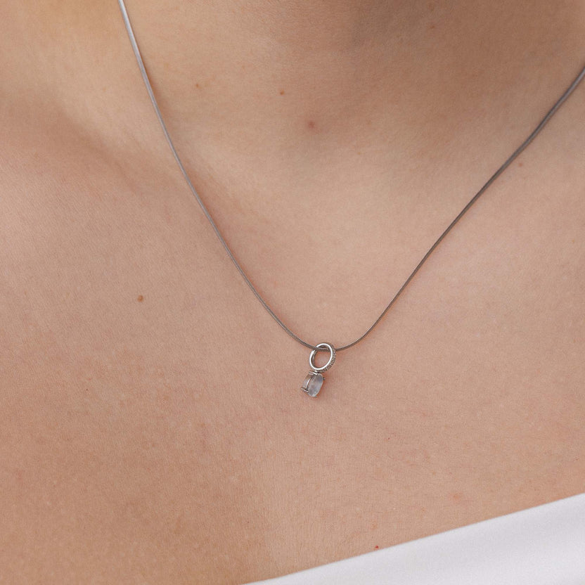 Silberne PURELEI Kette mit klarem Anhänger, elegant und feminin am Hals getragen.